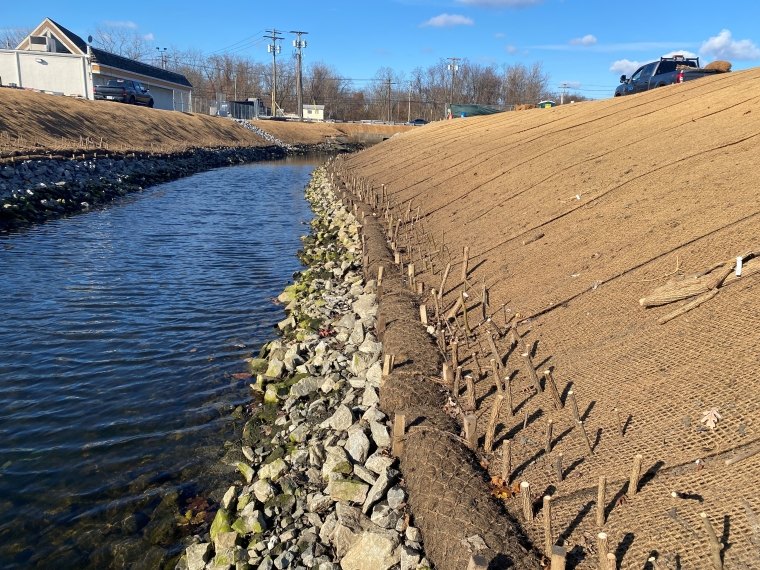 Coir logs, coconut fiber fabric, live stakes, and native seeding to stabilize bank and secure creek from erosion, Spring 2023