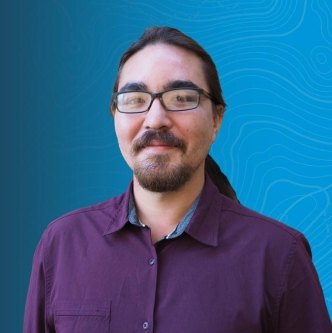 Headshot of Joshua Bailey, Senior Data Scientist, on a blue topographic background