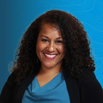 Headshot of Nicole Smolensky on a blue topographic background. 